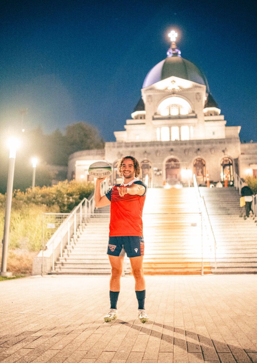 Brahim Mahmoudi in a rugby jersey in front of Saint Joseph's Oratory in Montréal, at night